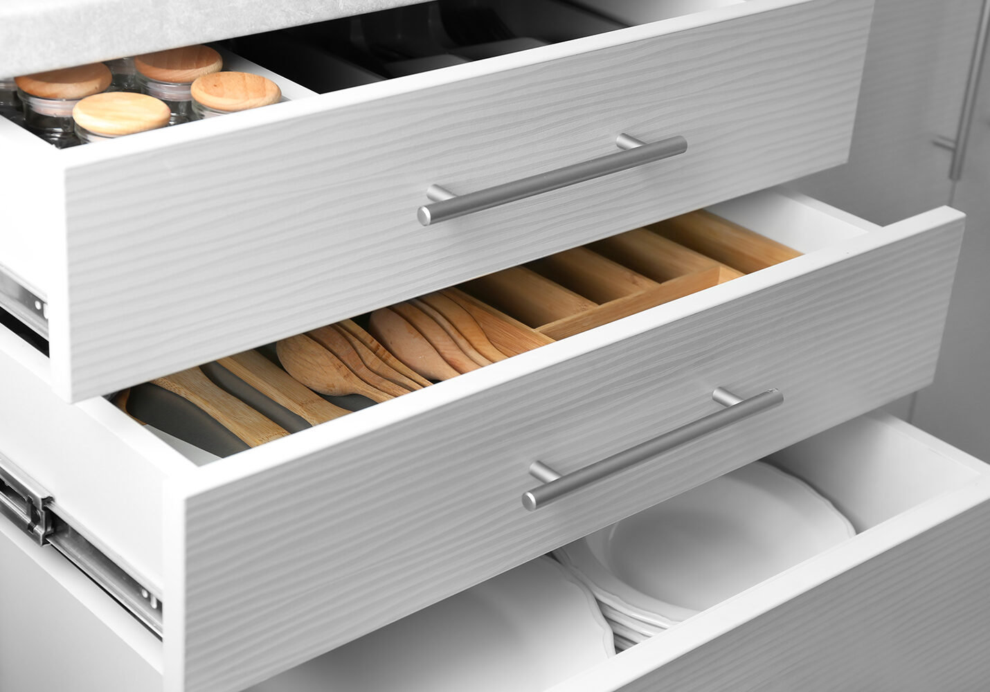 Set of ceramic plates and utensils in kitchen drawers